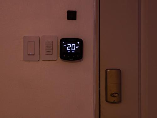 an alarm clock on a door with a clock on it at Garden Condos 39, Luxury Apartment In Sosua Town in Sosúa