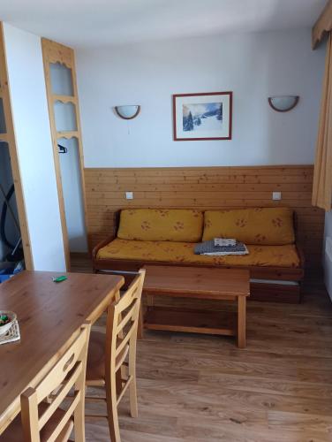 a living room with a couch and a table at Chamrousse - Résidence La Grive in Chamrousse