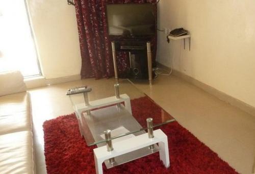 a living room with a coffee table and a couch at Vision Serviced Apartments in Asaba