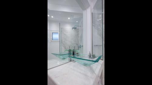 a bathroom with a glass sink and a shower at Dion Villa Zakynthos Greece One Bedroom Villa with Private Pool no01 in Agios Nikolaos