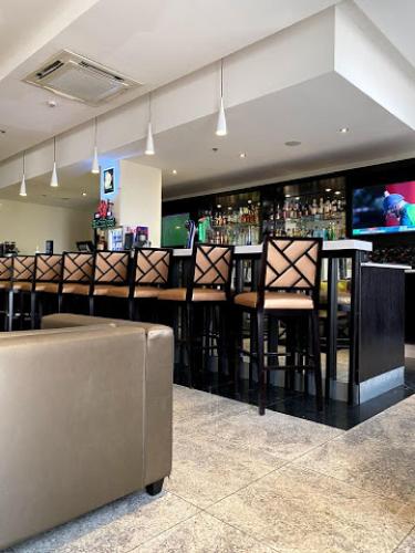 a bar with bar stools in a room at The Providence Hotel by Mantis in Ikeja