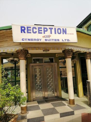 a building with a sign that reads respiration emergency clinics inc at Cynergy Suites Festac Town - Standard in Amuwo