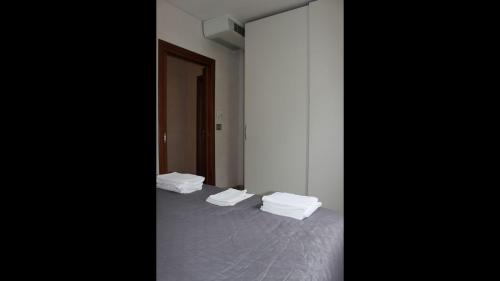 a room with a bed with four white sheets at Palazzo De Donno App no04 in Santa Cesarea Terme