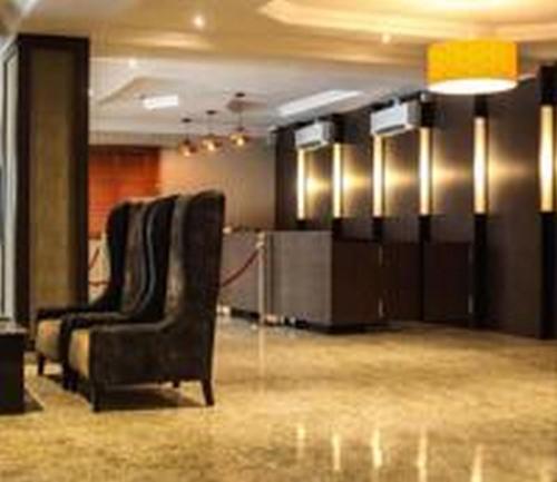 a conference room with two chairs and a desk at Christine Hotel - Christine Monarch in Port Harcourt