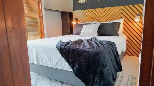 a bedroom with a bed with a blanket on it at Hb4 Double Room with Private Bathroom and Balcony in Cartagena de Indias