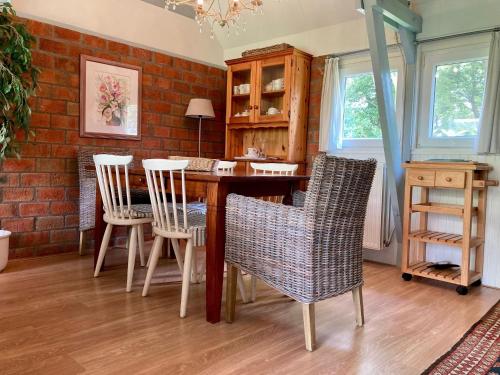 a kitchen with a table and chairs and a brick wall at Holiday house Viktoria at lake Lauwersmeer in Anjum