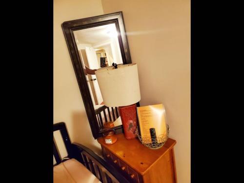 a table with a lamp and a mirror on it at Fall Room 3min From Yale, And Other Colleges in New Haven