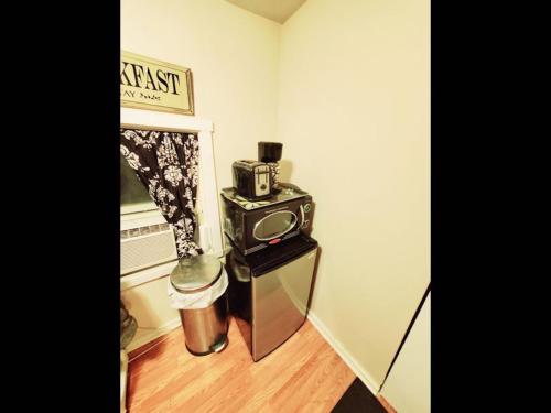 a small stove in a corner of a room at Fall Room 3min From Yale, And Other Colleges in New Haven