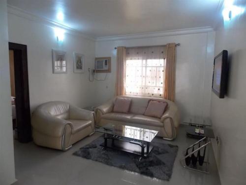 a living room with a couch and a table at Ayalla Hotel Suites-yenogoa Royal Room in Port Harcourt