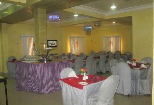 a banquet hall with chairs and tables and a room filled with at Ayalla Hotel Suites-yenogoa Royal Room in Port Harcourt