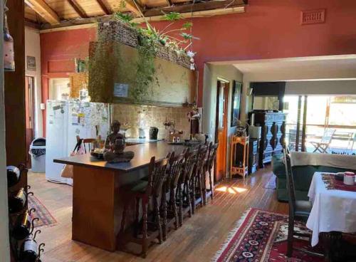 a kitchen with a large island in the middle of a room at Living In Camps Bay Summer in Cape Town