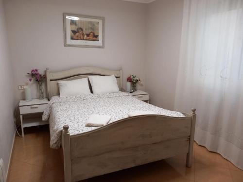 a bedroom with a bed and two tables and a picture at Cozy Apartment Near The Beach in Barcelona