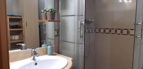 a bathroom with a sink and a shower at Cozy Apartment Near The Beach in Barcelona
