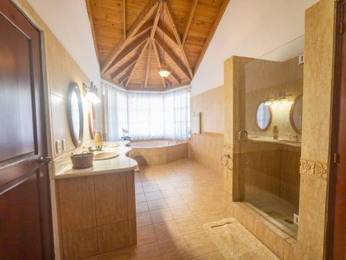 a large bathroom with a tub and a sink at Casati Pearl House, Big House With Private Pool in Bombita