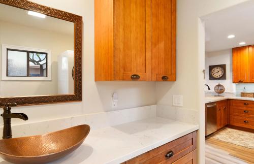 a bathroom with a sink and a mirror at Puamana 240-3 in Lahaina