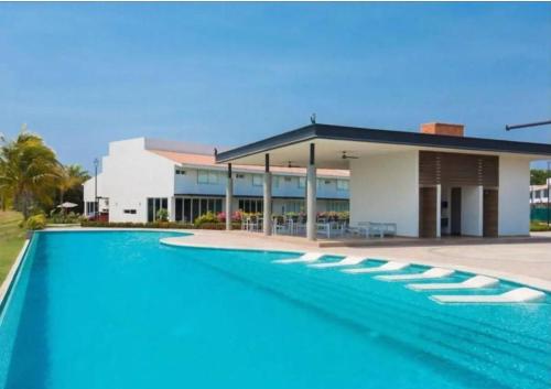 a large swimming pool in front of a building at New beautiful house in El Tigre, Golf Club, Punta Cala 205 in Nuevo Vallarta 