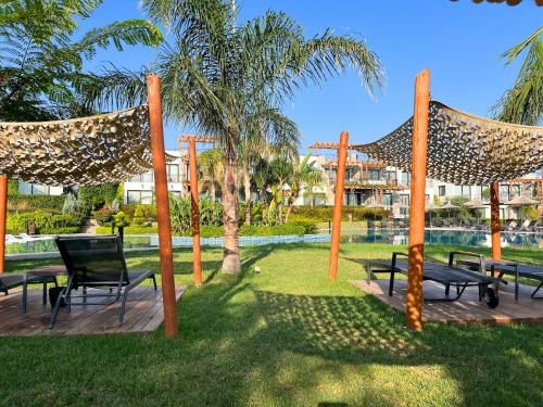 a group of benches and hammocks in a park at Luxurious Seafront Penthouse in Kérynia