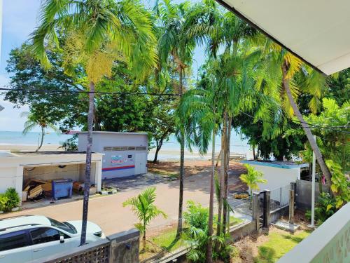 a view from the balcony of a house with palm trees at Port Dikson Beach Side Villa in Port Dickson