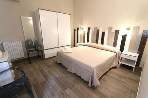 a bedroom with a bed and a large mirror at Le Stanze Apartament in Bologna