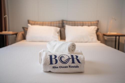 a pile of towels sitting on top of a bed at Charming and beautifully furnished apartment with direct poolside access in Ayios Nikolaos