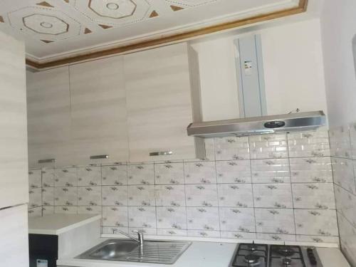 a kitchen with a sink and a stove at Villa Amina splendid elegant structure in Ouagadougou