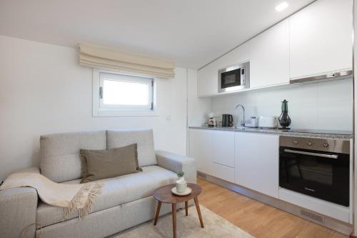 a living room with a couch and a kitchen at Matosinhos Seaside Comfy Flat in Matosinhos