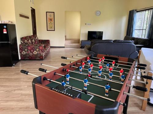 a room with a foosball table in the middle at Orchard Villa, Radiant Janda Baik in Bentong