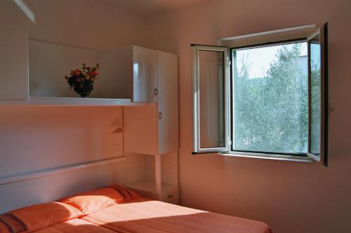 a bedroom with a bed and a window at Residence Sun Bay in Vieste