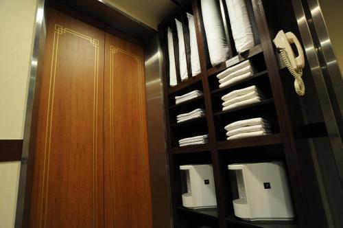 a room with a closet with white towels at Oita Regal Hotel in Oita