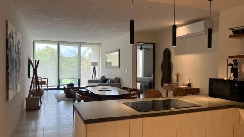 a kitchen and living room with a couch and a table at Penthouse Elementos Cozumel Torre Infinito in Cozumel