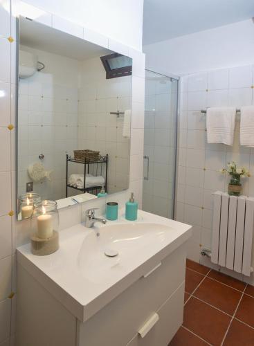 a bathroom with a white sink and a mirror at B&B Canneto Beach in Leporano