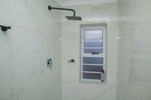 a bathroom with a shower with a window at One Bedroom apartment A3 in Cape Town
