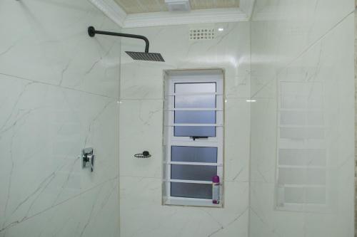 a bathroom with a shower with a window at One Bedroom apartment A3 in Cape Town