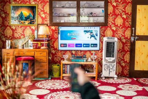 a person taking a picture of a living room at Grand Aurora Retreat in Srinagar