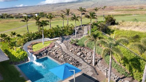 an aerial view of a pool with a waterfall and palm trees at ❤PiH❤ BLUE TRANQUILITY Heated Private Pool Spa Detached Ohana Suite in Waimea