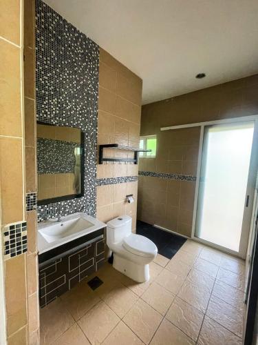 a bathroom with a toilet and a sink at Orchard Villa, Radiant Janda Baik in Bentong