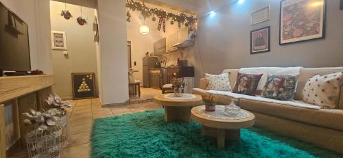 a living room with a couch and two tables at Elichrysos GuestHouse Konitsa in Konitsa