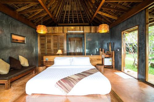 a bedroom with a large white bed in a room at Andalay Beach Resort Koh Libong in Ko Libong