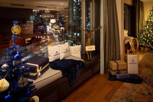 a christmas window with a christmas tree in a store at Hilton Frankfurt City Centre in Frankfurt/Main