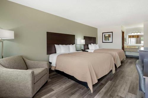 a hotel room with two beds and a couch at Quality Inn Siloam Springs West in Siloam Springs