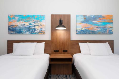 two beds in a hotel room with white sheets at La Quinta by Wyndham Rockport - Fulton in Rockport