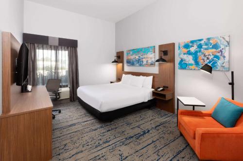 a hotel room with a bed and a couch at La Quinta by Wyndham Rockport - Fulton in Rockport