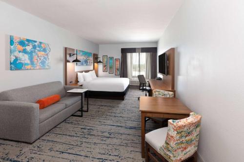 a living room with a couch and a bed at La Quinta by Wyndham Rockport - Fulton in Rockport