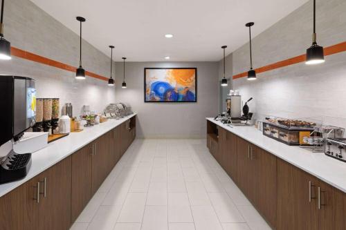 a large kitchen with a long line of counters at La Quinta by Wyndham Rockport - Fulton in Rockport