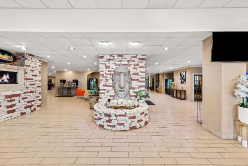 a lobby with a statue of a face on a brick wall at Comfort Inn & Suites Omaha Central in Omaha