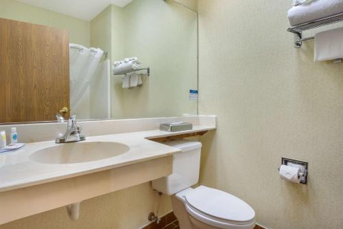 a bathroom with a sink and a toilet and a mirror at Comfort Inn Federal Way - Seattle in Federal Way