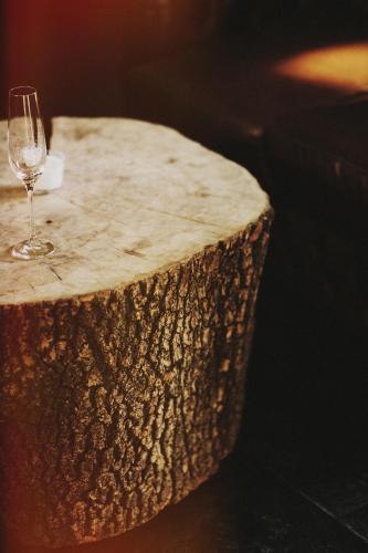 a glass of wine sitting on top of a tree stump at HOT_elarnia Hotel & Spa in Puszczykowo