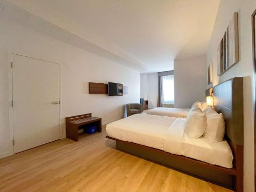 a hotel room with a bed and a television at Quality Inn in Quebec City