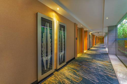 a hallway with paintings on the walls of a building at Meihao Mingyue Hotel International Finance City Keyun Road Metro Branch in Guangzhou