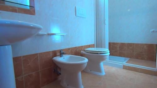 a bathroom with a toilet and a sink at Residence Sun Bay in Vieste